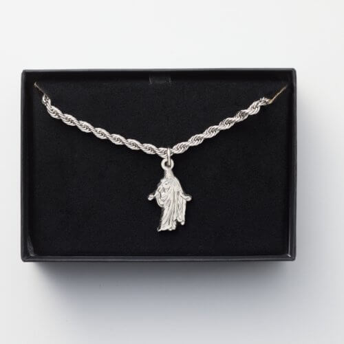 Silver rope chain with Christ risen emblem.